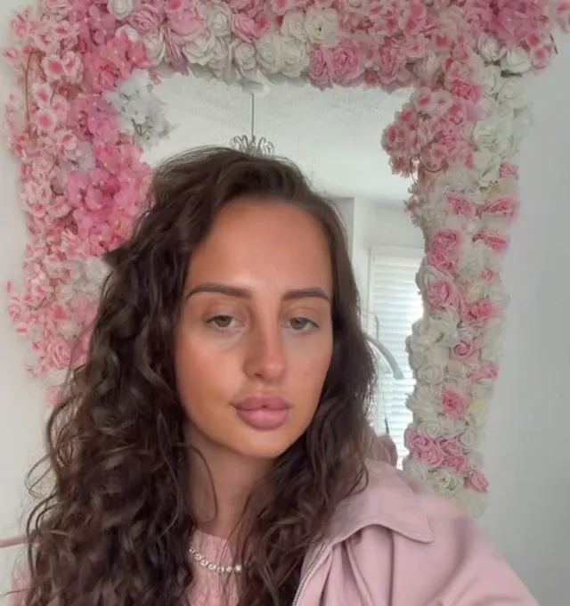 Maggie in front of the rose mirror in her beauty room